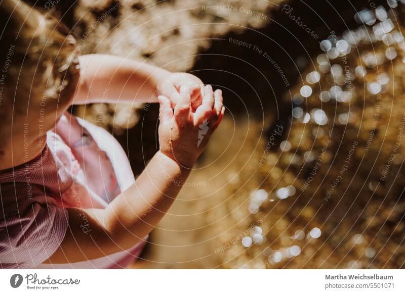 Kind spielt in Bach mit Sand und Kies Sandspiel Spielen im Freien spielen in der natur Spielen im Bach Natur Spielen mit Wasser Im Freien Sommer auf dem Land