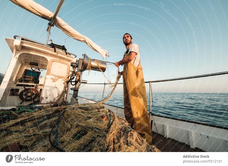 Fischer, der vom Segelboot aus im offenen Meer fischt Boot MEER Fischen Netz Schoner Arbeit Uniform männlich Soller Balearen Mallorca Wadenfisch jagen Trawler