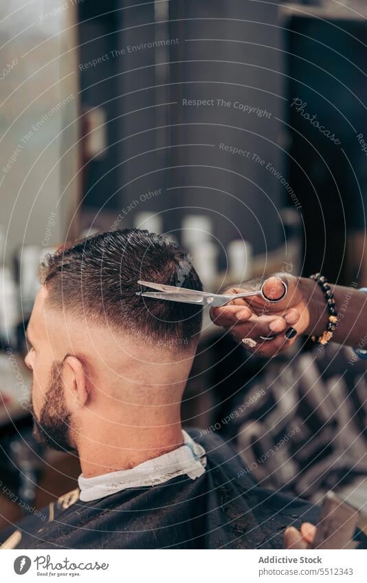 Schwarzer Friseur, der die Haare eines Kunden mit einer Schere schneidet Männer Klient geschnitten Kamm Haarschnitt Barbershop Behaarung Job jung männlich