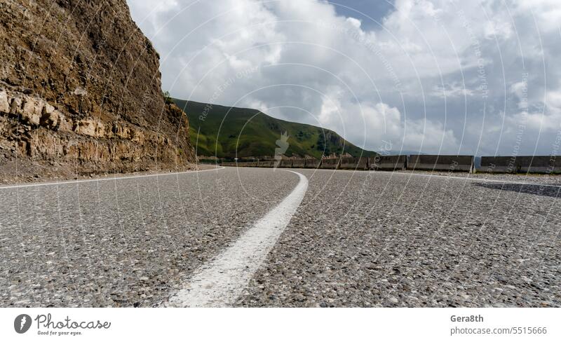 leere Straße in den Bergen ohne Menschen und ohne Autos Asphalt Herbst Hintergrund blau Klima Wolken Land Tag Regie Umwelt Gras grün Autobahn Hügel Landschaft