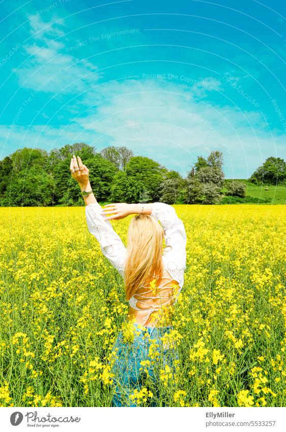 Junge blonde Frau im Rapsfeld jung Freiheit Portrait gelb Feld Natur Sommer Frühling Blühend Pflanze Blüte Umwelt Nutzpflanze Rapsblüte Landschaft Rapsanbau