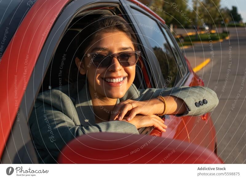 Schöne Geschäftsfrau mit Sonnenbrille im Auto Frau PKW attraktiv Porträt Glück jung Fahrer Blazer orange schön in die Kamera schauen Ausflug Lehnen Kopfschuss