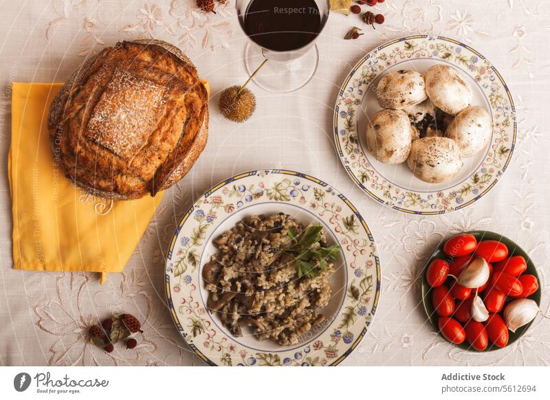 Rustikales hausgemachtes Pilz-Risotto und frische Zutaten Lebensmittel Mahlzeit rustikal selbstgemacht Brot Suppe Gemüse Tomate Teller Tasse Kaffee Leinen