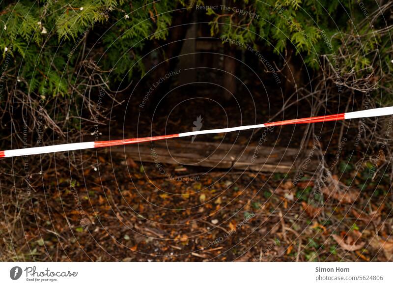 Absperrband vor dunklem Versteck Absperrung Höhle Eingang Sicherheit gruselig Dunkelheit Tatort verboten Durchgang Gefahr