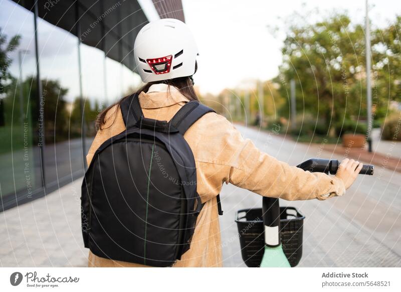 Urbaner Radfahrer mit Helm und Rucksack, der ein Smartphone hält urban Schutzhelm Pendeln Gebäude Stehen jung Fernglas Großstadt Transport Handy Fangvorrichtung