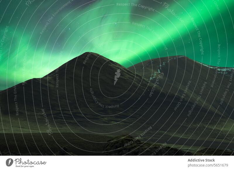 Glatte, schneebedeckte Berge unter dem Nordlicht in Island Berge u. Gebirge Schnee Verschlussdeckel Nacht grüner Himmel Naturwunder Landschaft im Freien sanft