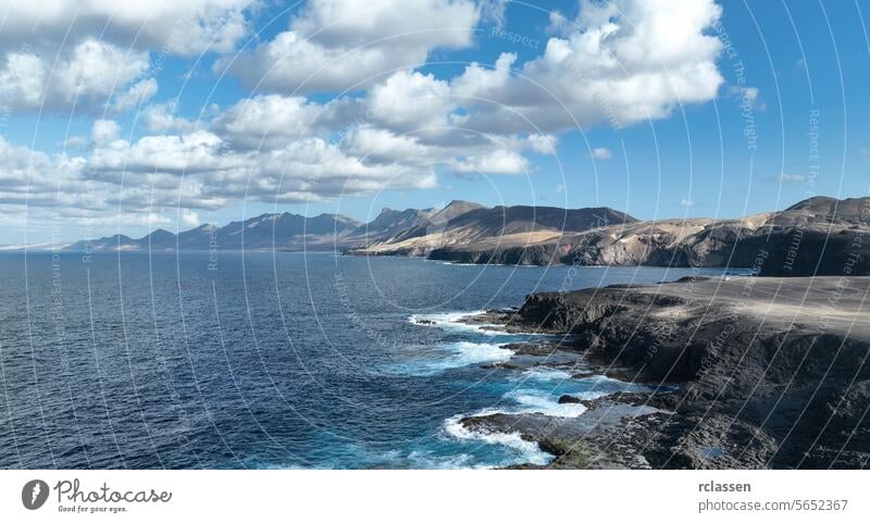 Strand von Cofete mit endlosem Horizont. Vulkanische Hügel im Hintergrund und der Atlantische Ozean. Strand von Cofete, Fuerteventura, Kanarische Inseln, Spanien. Arial-Ansicht