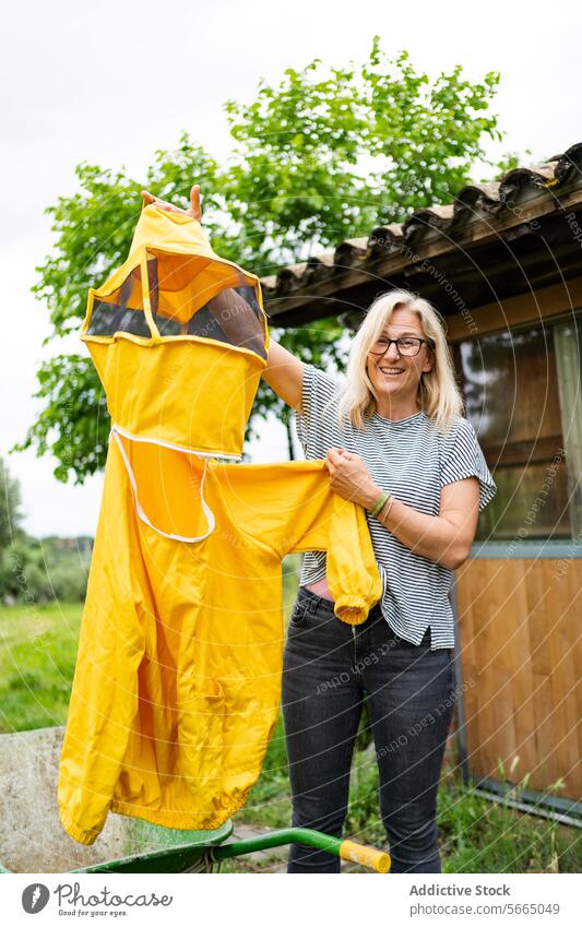 Fröhliche Frau in Imkerkostüm mit Schleier Glück Lächeln manifestieren heiter positiv behüten Anzug Imkerschleier Erwachsener freundlich Landschaft stehen grün