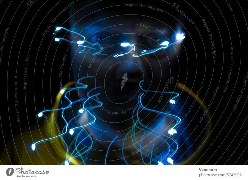 Lichtspuren vor einem Gesicht eines Mannes, Hintergrund Schwarz, Unschärfe Mann mittleren Alters Maennlich Augen Lichtspielerei Langzeitbelichtung abstrakt