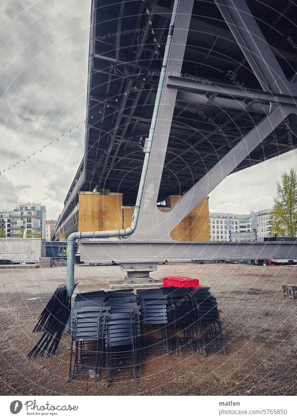 Gartenstühle unter Brücke Gartenstuhl Zusammengeklappt Himmel Wolken Berlin Gleisdreieck Menschenleer Neubauten U-Bahn Tag Öffentlicher Personennahverkehr