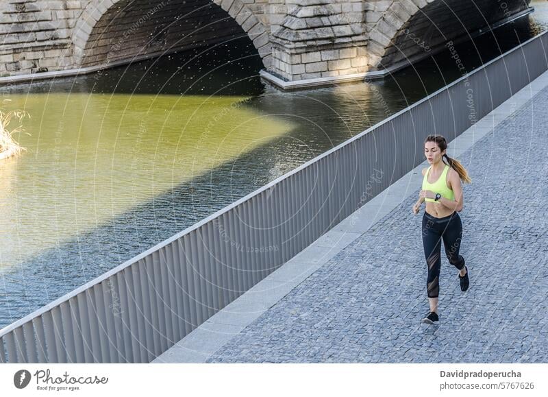 gesunde glückliche Frau Joggen Laufen im Freien Musik hören laufen rennen Fitness strecken Übung jung Kopfhörer Training Gesundheit Sport passen schön Lifestyle