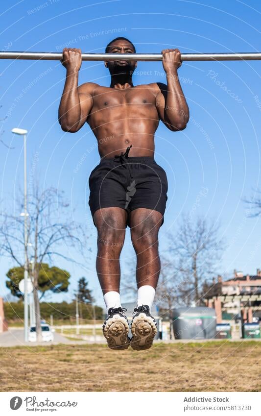 Starker schwarzer Sportler beim Training an der Bar in der Stadt hochziehen Übung muskulös stark Mann Muskel Fitness Sportbekleidung Afroamerikaner Kraft