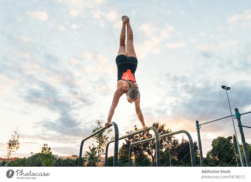 Sportlerin beim Handstand am Barren Kunstturnen Athlet Sportbekleidung stark Frau Aktivität Übung muskulös Training sportlich Gesundheit Lifestyle calisthenics