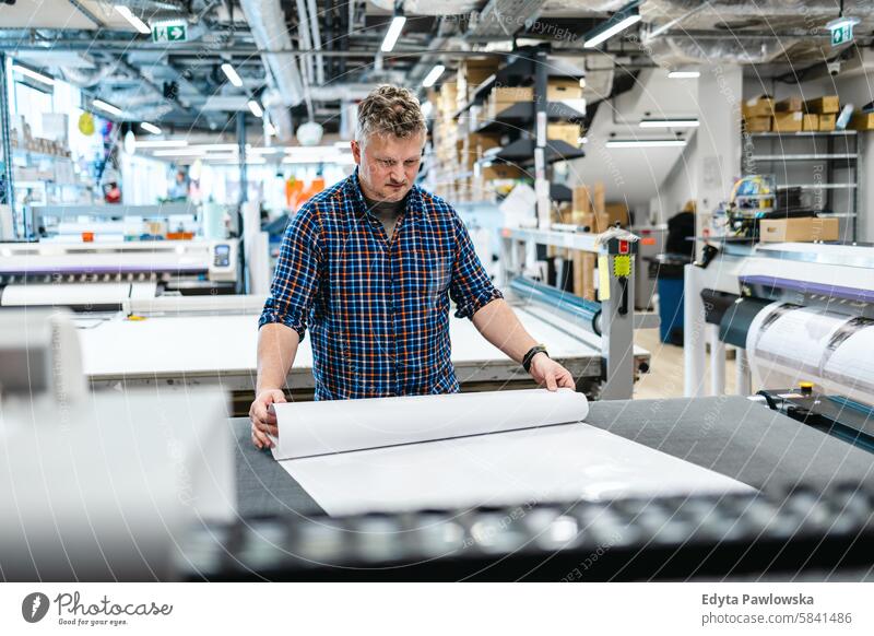 Mann bei der Arbeit in einer Druckerei Business Mitarbeiter Fabrik männlich industriell Industrie Job Güterverkehr & Logistik Herstellung Beruf Menschen