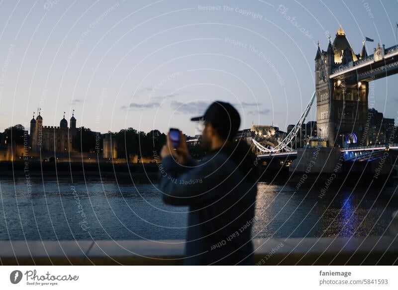 Tourist in London beim Fotografieren des Tower of London Tourismus Fotos machen spaziergang nacht nachts abends Kappe Basecap England Großbritannien