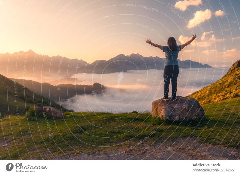 Rückenansicht einer nicht erkennbaren Person, die den Sonnenaufgang in den Picos de Europa genießt Berge u. Gebirge Wolken Tal unkenntlich Frau Rückansicht