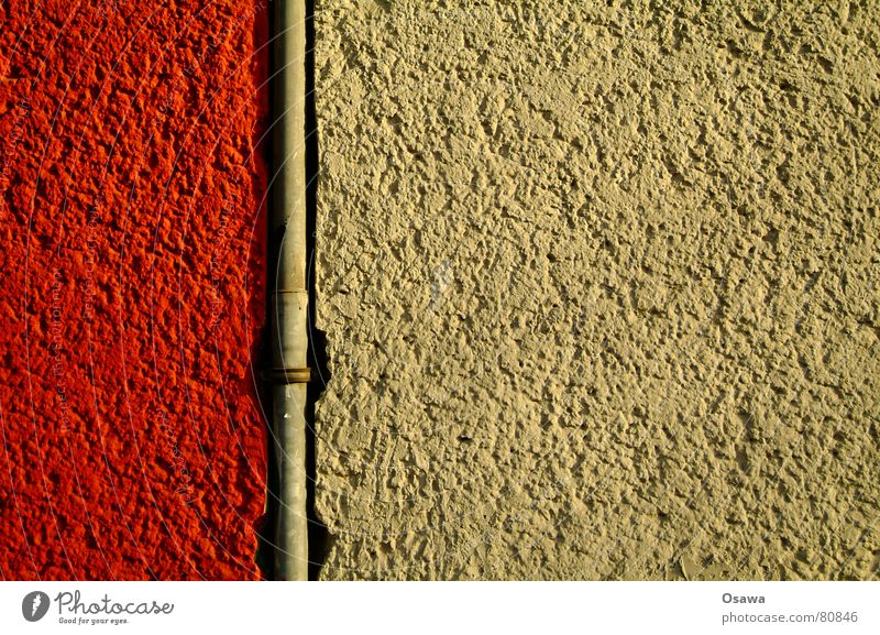 Regenrohr Wand Gebäude Putz Fallrohr Stahl rot beige Bauwerk Mauer Steigrohr Detailaufnahme rohrschelle entwässerung. balkonentwässerung dachentwässerung