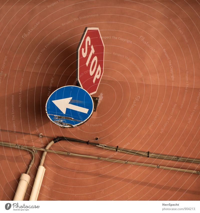 stop & go Gebäude Mauer Wand Verkehr Verkehrszeichen fahren stoppen Stoppschild zerkratzen Schramme Pfeil Kabel orange braun beschädigt kaputt Kratzer Farbfoto