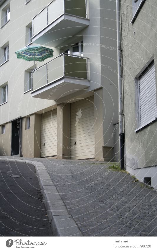 Straßenkomposition Sonnenschirm grau Asphalt Balkon Wand Fassade Garage Bürgersteig Bordsteinkante Fenster türkis Verkehrswege hellgrau