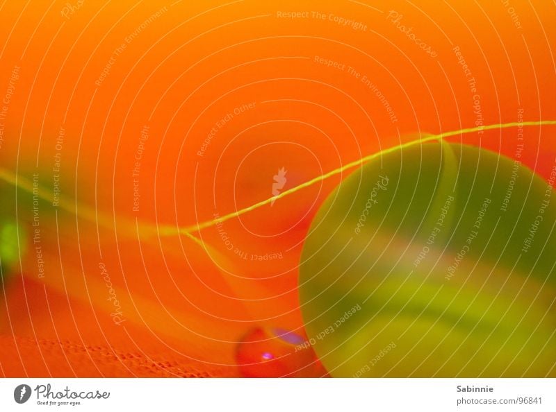 Planeten im Winzformat winzig grün klein Glasperle Stoff Nähgarn Kunststoffperle Makroaufnahme Nahaufnahme Perle orange Chiffon