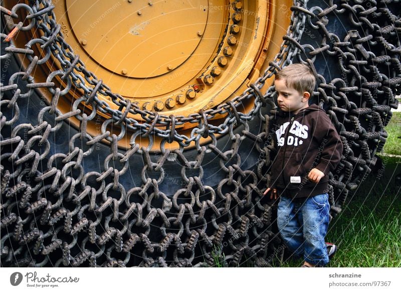 Bub und Maschine Junge Kleinkind Kind Reifen Baustelle Denken groß klein Macht entdecken Lastwagen Industrie Boy Mensch Kette nachdenken Gefährt Trax