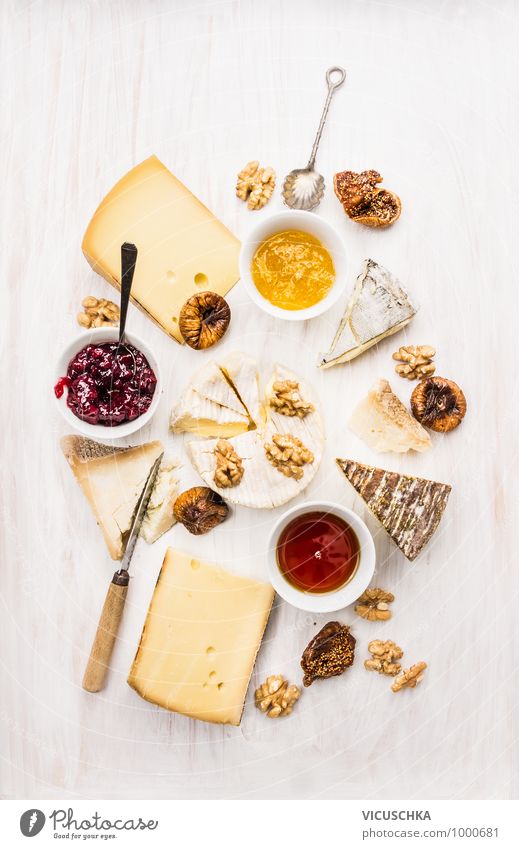 different kinds of cheese with sauce, walnuts and figs Style Design Soft Yellow Brie roquefort camembert Cheese varieties Difference Sauce Bowl Spoon Knives