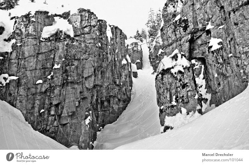 ice binge Canyon Tunnel Mining Digging Quarry Winter Gravel Passage Go up Footprint Crash Dangerous Cold Black & white photo Mountain Stone Rock Snow Ice Silver