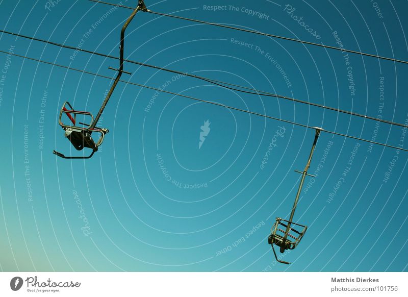 chair lift Chair lift Steel Green Alpine Blue Tilt Incline Skilift chair 2 In pairs Steel cable Downward Skyward Diagonal Bright background Isolated Image