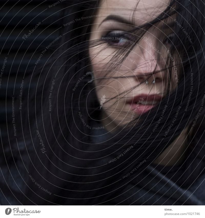 Woman in wind Feminine Young woman Youth (Young adults) 1 Human being Coat Piercing Earring Black-haired Long-haired Observe Think Looking Wait Rebellious