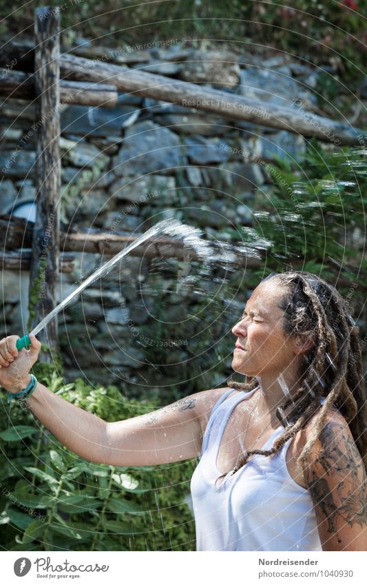 Young woman with dreadlocks refreshes herself under a jet of water Lifestyle Joy Summer Human being Feminine Youth (Young adults) 1 Garden T-shirt Tattoo