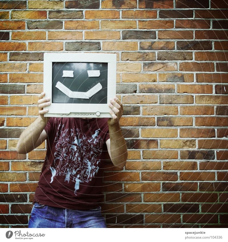 computer nerd Screen Man Portrait photograph Wall (building) Freak Brick Crazy Whimsical Joy Computer Stone Grinning Laughter Hide Hiding place Funny