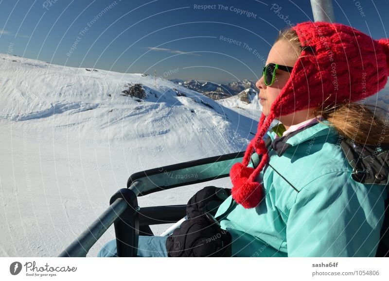 Young girl on chair lift at ski resort Lifestyle Relaxation Vacation & Travel Winter Snow Winter vacation Mountain Chair Sports Skiing Human being Girl Woman