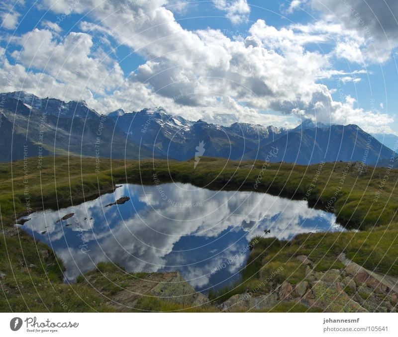 A deep sea Lake Mountain lake Clouds Alpine pasture Canton Wallis Peak Reflection Switzerland Sky Alps Weather Wind