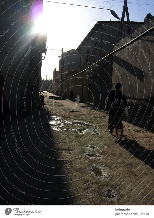 puddles Back-light Puddle Reflection Bicycle Uzbekistan Buchara Asia Alley Village Exterior shot Traffic infrastructure Water Human being dreamed away Tradition