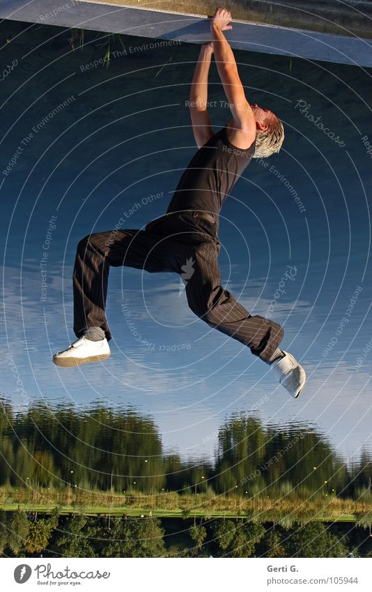 grip Hold To hold on Kick about Fidget Hang Man Black Green Tree Reflection Water reflection Lake Clouds Sky blue Gymnastics Droop Strong Force Dangerous