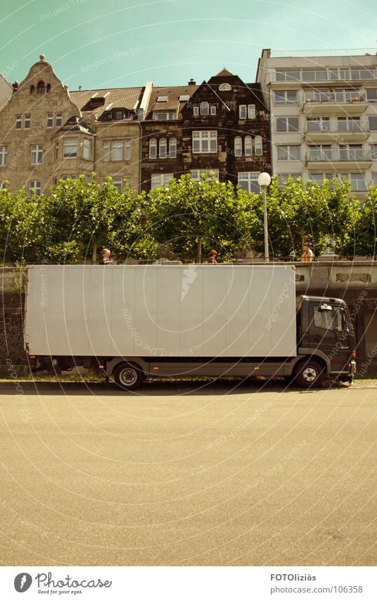 Catwalk: Charging station Rhine Promenade Truck Unload Pedestrian Asphalt Tree Town house (Terraced house) Lantern Goods Green Cyan Beige Brown Window