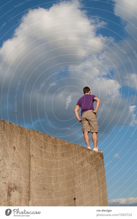 Young person standing on an old concrete wall from the frog's perspective people Face one person Wall (barrier) Wall (building) Concrete Concrete wall