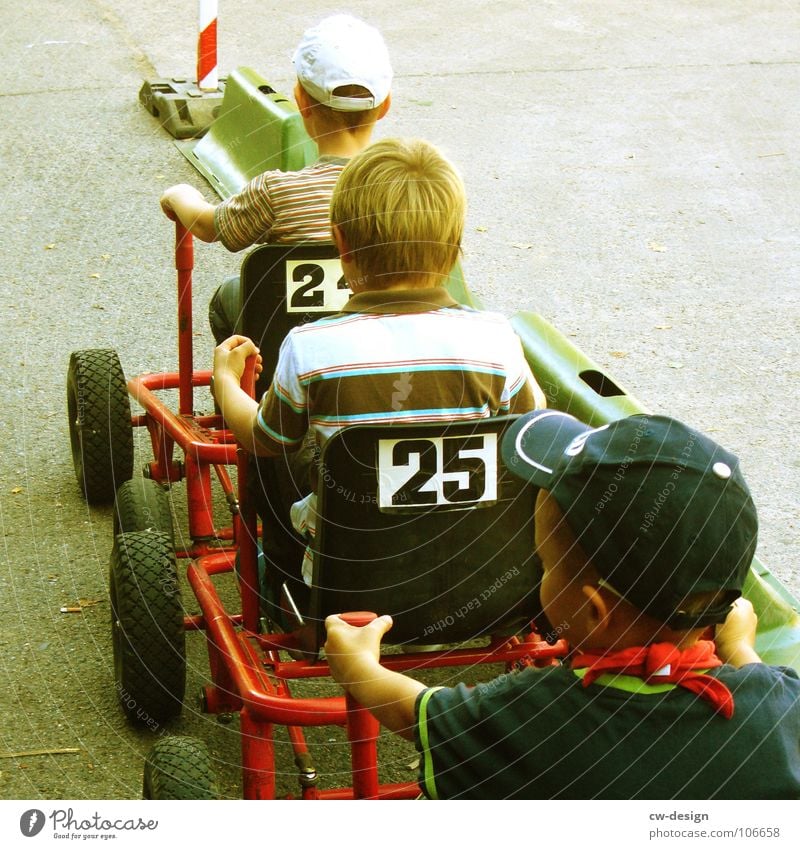 at full throttle! Child Playground Playing Driving Stand Sandpit Sporting grounds Traffic lane Racecourse Stop Signage Warning sign Roadside Lane markings