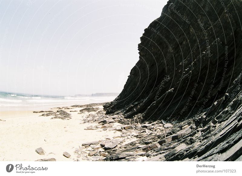 Stony ascent Beach Fisheye Granite Black Incline Deserted Ocean Waves Portugal Summer Stone Rock Sand Shift work Mountain