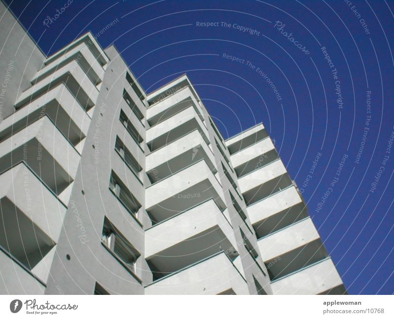 block of flats Schöneberg Tower block Balcony White Concrete Worm's-eye view Architecture Graffiti Prefab construction Blue sky Escape