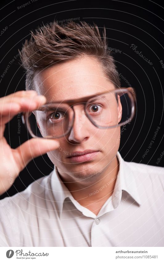 Young man has glasses in hand and looks through glasses in shock Shopping Joy Science & Research Study University & College student Human being Masculine