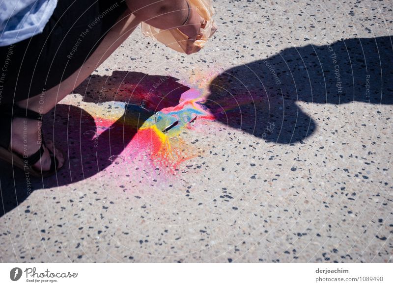 A dropped paint bottle is picked up by the mother. Child as shadow . Joy Life Trip Summer Stoop Feminine Mother Legs Outskirts Queensland Australia Town