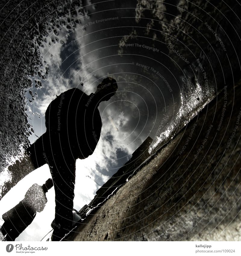 gutter boys Puddle Water puddle Man Surface of water Water reflection Silhouette Curbstone Mirror image