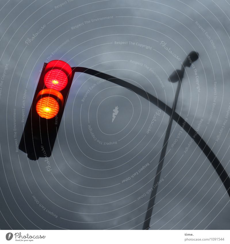 geometric | pole position - traffic light red-yellow in front of sky with dark grey clouds Transport Road sign Street lighting Traffic light Illuminate Creepy