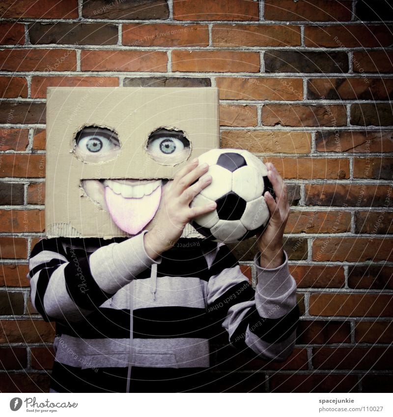 Playing football Man Cardboard Whimsical Humor Wall (building) Freak Square Brick Joy Face Mask Hiding place Hide Stone Ball Soccer Sports square skull