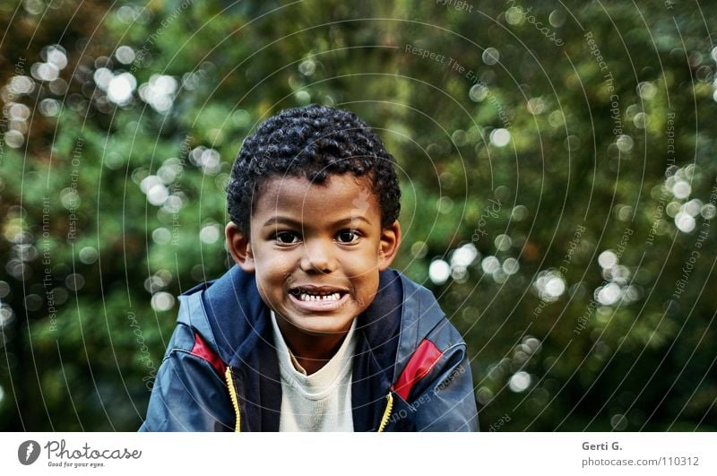 show teeth Portrait photograph Beautiful Skin color Bushes Tree Green Dark green Rain jacket Facial expression Face Nursery school child Child Show your teeth