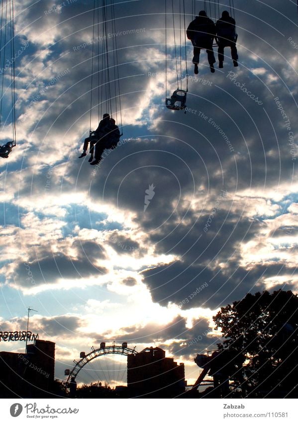 skyscraper Carousel Speed Rotate Filming Circle Clouds Human being Light Ferris wheel Prater Vienna Austria Tree Black Gray Cyan Sunset Building