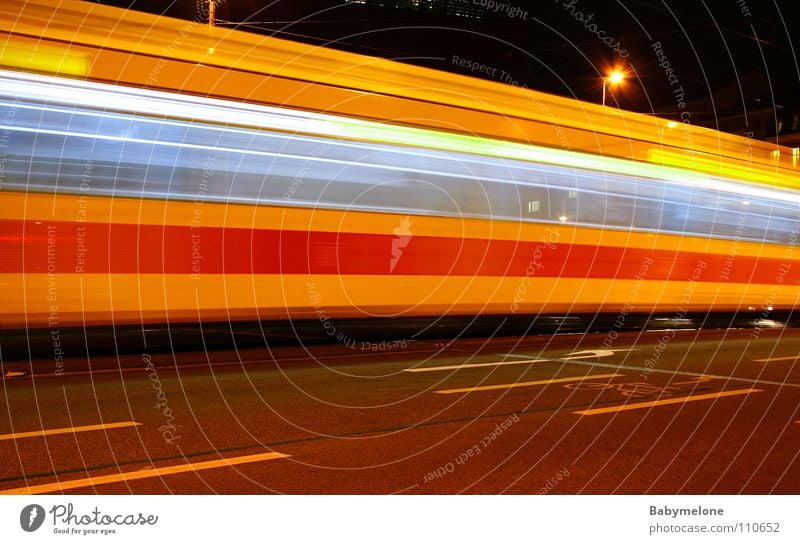 At express train speed Tram Transport Town Basel Railroad Railroad tracks Yellow Red Speed Long exposure Blur Night Dark Movement motion Train station Street