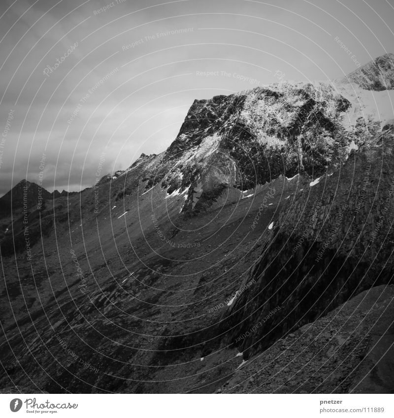 lonely mountain Clouds Black White Vacation & Travel Dangerous Slope Steep Black & white photo Mountain bersch Tall Snow Stone Sky Climbing Threat