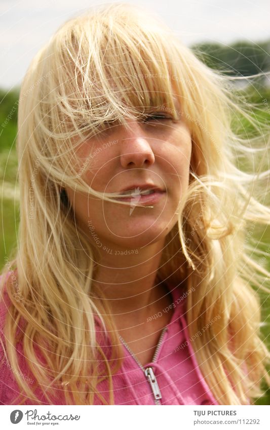 Golden Hair jule Blonde Long-haired Portrait photograph Woman Pink Green Meadow Tousled Disheveled Hooded sweater Lascivious Air Wind Dreamily Girlish